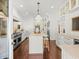 Bright kitchen featuring stainless steel appliances, an island and a breakfast bar at 803 S Packwood Ave, Tampa, FL 33606