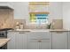 Bright kitchen with apron sink, marble countertops, and stainless steel appliances at 803 S Packwood Ave, Tampa, FL 33606