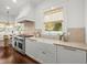 Bright kitchen boasts a farmhouse sink, stainless steel appliances and marble countertops at 803 S Packwood Ave, Tampa, FL 33606