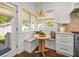 Kitchen nook with a built-in bench, round table, and bright windows at 803 S Packwood Ave, Tampa, FL 33606