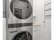 Modern laundry room with stacked washer and dryer, and ample storage space at 803 S Packwood Ave, Tampa, FL 33606