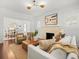 Bright living room with a fireplace, hardwood floors, modern lighting, and elegant decor at 803 S Packwood Ave, Tampa, FL 33606