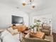 Stylish living room featuring hardwood floors, modern lighting, and an open layout to the dining area at 803 S Packwood Ave, Tampa, FL 33606