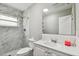 Updated bathroom featuring a vanity and shower/tub with marble-look tile at 803 W Warren St, Plant City, FL 33563