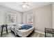 Bedroom with two windows, ceiling fan, and gray wood-look vinyl flooring at 803 W Warren St, Plant City, FL 33563