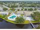 Aerial view showcasing community amenities including a pool, clubhouse, and surrounding greenery at 8220 112Th N St # 206, Seminole, FL 33772