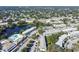 Picturesque aerial view of the community showcasing lush landscaping, a serene lake, and well-maintained buildings at 8220 112Th N St # 206, Seminole, FL 33772