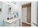 Bathroom features a vanity with a white countertop, updated faucet, and a cabinet for storage at 8220 112Th N St # 206, Seminole, FL 33772