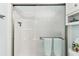 Clean bathroom with frosted glass enclosed shower, white tiles, and updated fixtures at 8220 112Th N St # 206, Seminole, FL 33772