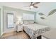 Comfortable bedroom with a queen-size bed, ceiling fan, and private access to the outside at 8220 112Th N St # 206, Seminole, FL 33772