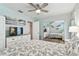 Inviting bedroom with calming light blue walls, a ceiling fan, and a mirrored closet with shelving at 8220 112Th N St # 206, Seminole, FL 33772