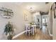 Cozy dining area featuring a round table, white chairs, and modern lighting at 8220 112Th N St # 206, Seminole, FL 33772