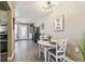 Charming dining area adjacent to the kitchen and living room, illuminated by a modern chandelier at 8220 112Th N St # 206, Seminole, FL 33772