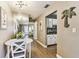 Cozy dining area with wood floors, a modern chandelier, and an accent mirror that reflects into the living spaces at 8220 112Th N St # 206, Seminole, FL 33772