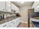 Compact kitchen featuring stainless steel appliances, white cabinets, and stylish countertops at 8220 112Th N St # 206, Seminole, FL 33772