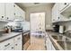 The cozy kitchen features updated appliances, and white cabinetry, and opens to the adjacent dining room at 8220 112Th N St # 206, Seminole, FL 33772