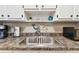 Close-up of the stainless steel kitchen sink with a decorative mermaid figurine and white cabinetry at 8220 112Th N St # 206, Seminole, FL 33772