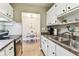 The kitchen area features white cabinetry, stainless appliances, and granite countertops at 8220 112Th N St # 206, Seminole, FL 33772