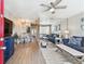 Open-concept living area with wood floors, ceiling fan, and a mirrored wall for added spaciousness at 8220 112Th N St # 206, Seminole, FL 33772