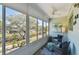 Relaxing screened-in porch with great views of the surrounding neighborhood, a ceiling fan, and comfortable seating at 8220 112Th N St # 206, Seminole, FL 33772