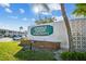Entrance sign for Seminole Garden Apartments with lush green lawn and trees, promoting a welcoming atmosphere at 8220 112Th N St # 206, Seminole, FL 33772