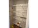 Linen closet with laminate flooring and white shelving at 8402 111Th St # 303, Seminole, FL 33772