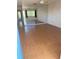 Bright living room with laminate flooring, ceiling fan, and large windows with exterior views at 8402 111Th St # 303, Seminole, FL 33772