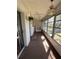 Relaxing sunroom with ceiling fans, hanging plant, carpet flooring and view to the outdoors at 8402 111Th St # 303, Seminole, FL 33772