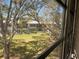 Window view to beautifully landscaped exterior grounds with mature trees at 8402 111Th St # 303, Seminole, FL 33772