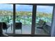 Enjoy scenic views from this condo balcony with comfortable seating at 880 Mandalay Ave # N802, Clearwater Beach, FL 33767