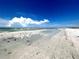 Expansive beach with blue skies and puffy white clouds at 880 Mandalay Ave # N802, Clearwater Beach, FL 33767