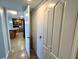 Hallway leading into kitchen; features white closet doors for storage and tile flooring throughout at 880 Mandalay Ave # N802, Clearwater Beach, FL 33767