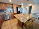 Spacious kitchen with granite counters, stainless appliances, and a center island with bar seating at 880 Mandalay Ave # N802, Clearwater Beach, FL 33767