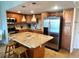 Open kitchen with stainless steel appliances, granite counters, and a center island with seating at 880 Mandalay Ave # N802, Clearwater Beach, FL 33767