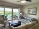 Cozy living room with comfortable seating and a balcony offering scenic views at 880 Mandalay Ave # N802, Clearwater Beach, FL 33767