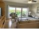 Well-lit living room showcasing a neutral color palette, tile flooring, and a sliding glass door at 880 Mandalay Ave # N802, Clearwater Beach, FL 33767