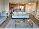 Cozy living area featuring a comfortable sofa and an open kitchen at 880 Mandalay Ave # N802, Clearwater Beach, FL 33767