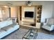 Bright living room with a TV, shelving units, and seating at 880 Mandalay Ave # N802, Clearwater Beach, FL 33767
