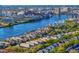 Stunning aerial view of waterfront homes with private docks and city skyline in the distance on a sunny day at 926 Anchorage Rd, Tampa, FL 33602