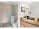 Elegant bathroom with a glass-enclosed shower, granite countertop vanity and ample lighting at 926 Anchorage Rd, Tampa, FL 33602
