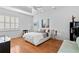 Bright bedroom features hardwood floors, white walls, a ceiling fan, and large window with shutters at 926 Anchorage Rd, Tampa, FL 33602