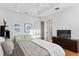 Comfortable bedroom featuring hardwood floors, white walls, modern ceiling fan, and an ensuite bathroom at 926 Anchorage Rd, Tampa, FL 33602