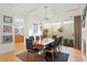 Dining room with modern chandelier, hardwood floors, seating for eight, and exterior view at 926 Anchorage Rd, Tampa, FL 33602