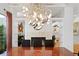 Dining room features a chandelier and fireplace, enhanced by built-in shelving and art at 926 Anchorage Rd, Tampa, FL 33602