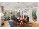 Dining room with modern chandelier, fireplace, hardwood floors, seating for eight, and exterior view at 926 Anchorage Rd, Tampa, FL 33602