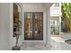 Grand front door and entrance featuring exterior art and view to the pool at 926 Anchorage Rd, Tampa, FL 33602