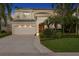 Elegant two-story home with a three-car garage, lush landscaping, and a welcoming front entrance at 926 Anchorage Rd, Tampa, FL 33602