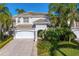 Elegant two-story home with manicured landscaping, a three-car garage, and a welcoming front entrance at 926 Anchorage Rd, Tampa, FL 33602