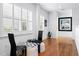 Bright hallway with hardwood floors, plantation shutters, and a chess table with chairs, offering an inviting space at 926 Anchorage Rd, Tampa, FL 33602