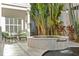 An outdoor hot tub and seating area surrounded by lush tropical foliage creates a relaxing space at 926 Anchorage Rd, Tampa, FL 33602